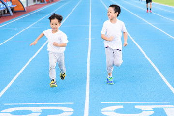 Fototapeta premium Boy runnin on blue track