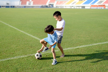 Boy play football on the lawn