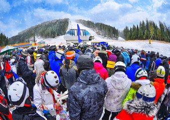 People stand before ski lift in queue in Bukovel , Ukraine