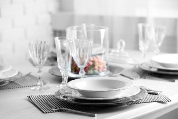Table set at restaurant on light background