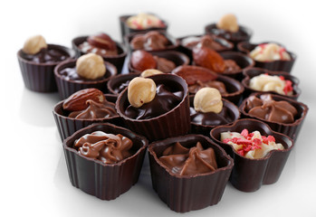 Delicious chocolate candies on white background