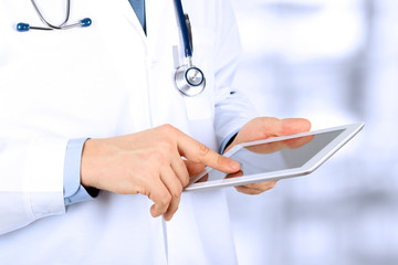Doctor working with tablet computer.