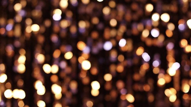 Abstract glittering lights, gold background, a real shot video in the blur
