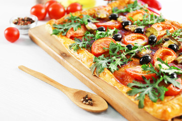 Rectangle delicious pizza and vegetables on the table