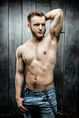Fototapeta premium Attractive young Man posing wearing jeans