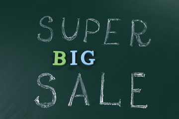 Super big sale concept on a blackboard background