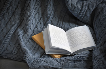 A book on knitted blanket. Peace and comfort concept