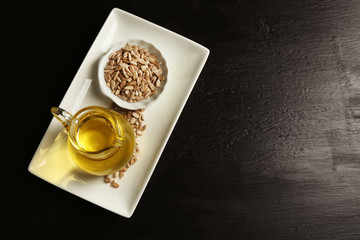 Sunflower seeds with oil on wooden table