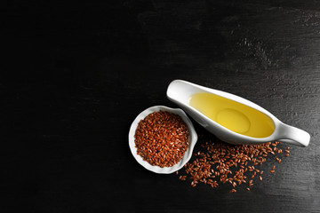 Flax seeds with oil on wooden table