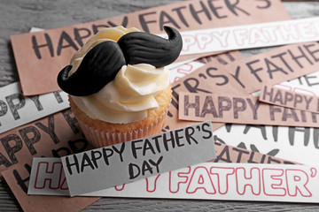 Happy fathers day special cupcake with mustache on wooden table