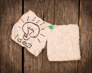 pieces of paper with the word idea on a wooden background