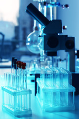 Microscope and different test tubes and flasks in laboratory
