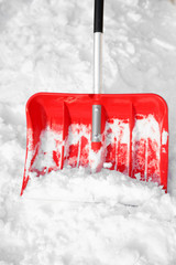 Red plastic shovel for snow