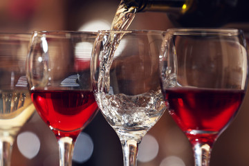 White wine pouring into wine glass, closeup