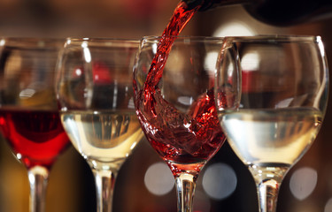 Red wine pouring into wine glass, closeup
