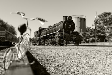 Wired eMotion -Steam train readying to leave the station with a wired bicycle