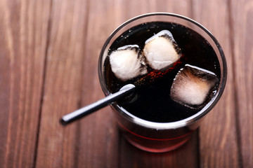 Cocktail with ice blocks and tubule  on wooden background, top view