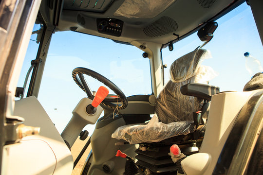 interior view of cultivator tractor cabin with steering wheel