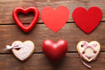 Set of different hearts on wooden background