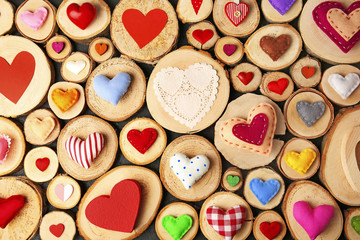 Valentine's Day concept. Different handmade hearts on wooden stumps background