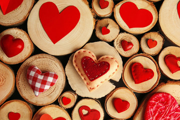 Valentine's Day concept. Different colourful hearts on wooden stumps background