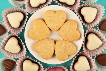 Valentine's Day concept. Composition of delicious chocolate candies and tasty cookies, close up