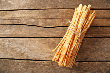Bread sticks grissini with sesame seeds on a wooden table