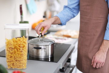 Man cooking pasta in kitchen