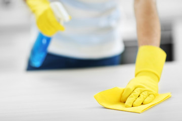 Man cleaning kitchen with spray and rag