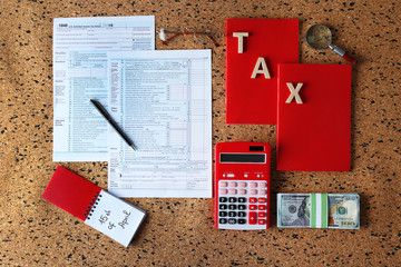 Individual income tax return, form 1040 with calculator and notebook on table