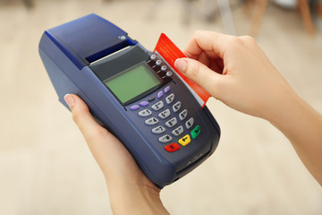 Female hands with credit card and bank terminal