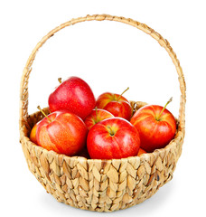 Wicker basket with red juicy apples isolated on white background