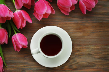 Fresh pink tulips on a wooden table, top view