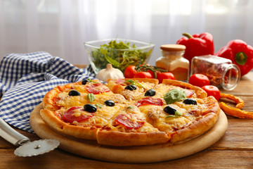 Fresh baked pizza on a wooden table, close up