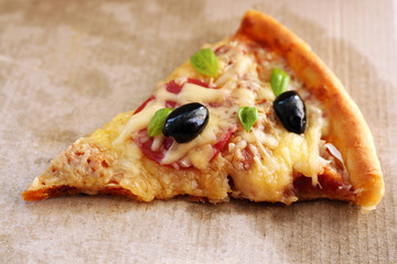 Slice of fresh baked pizza, close up