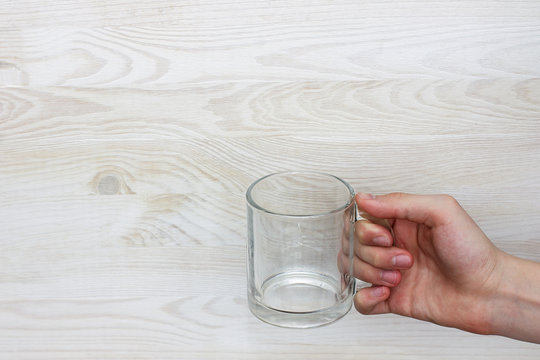 vital necessity in water/empty transparent glass of water in her hand