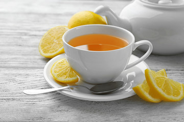 Cup of tea with ginger on a light wooden background