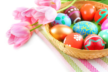 Fototapeta na wymiar Multicoloured Easter eggs and tulips on napkin, closeup