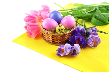 Multicoloured Easter eggs and tulips on napkin isolated on white