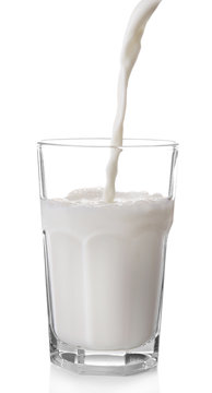 Pouring milk in glass, isolated on white