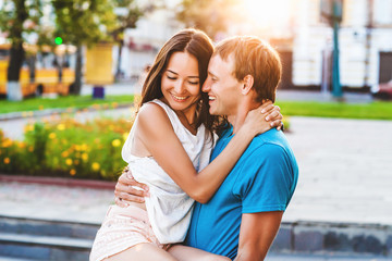 beautiful young brunette girl hugging a loved one guy