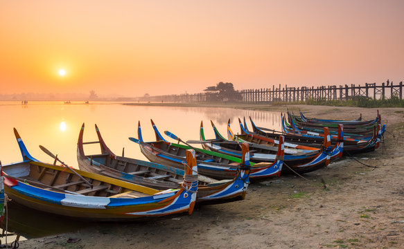 Wooden boat in Ubein Bridge at sunrise, Mandalay, Myanmar