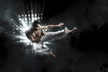 Fototapeta na wymiar male fighter trains capoeira