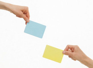 Human hands holding colorful paper cards