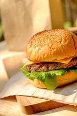 Yummy Beef and cheese Hamburger place on wood tray