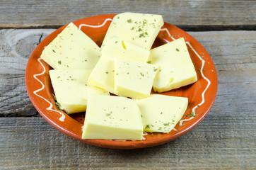 Shredded cheese on a clay plate