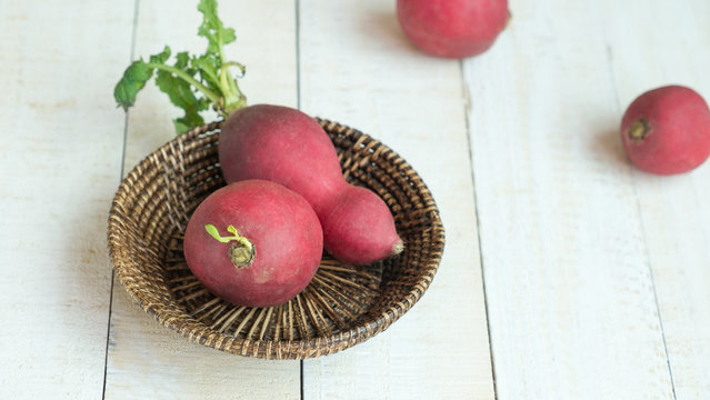 Radishs in basket on white background