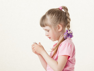 Pretty little girl reading the text on a card