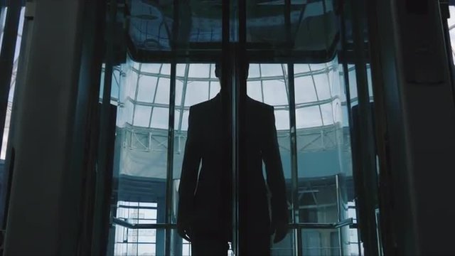 Businessman out of a glass elevator