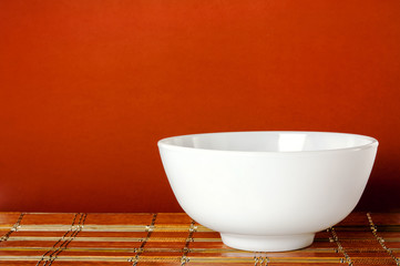 White dishes on bamboo mats.